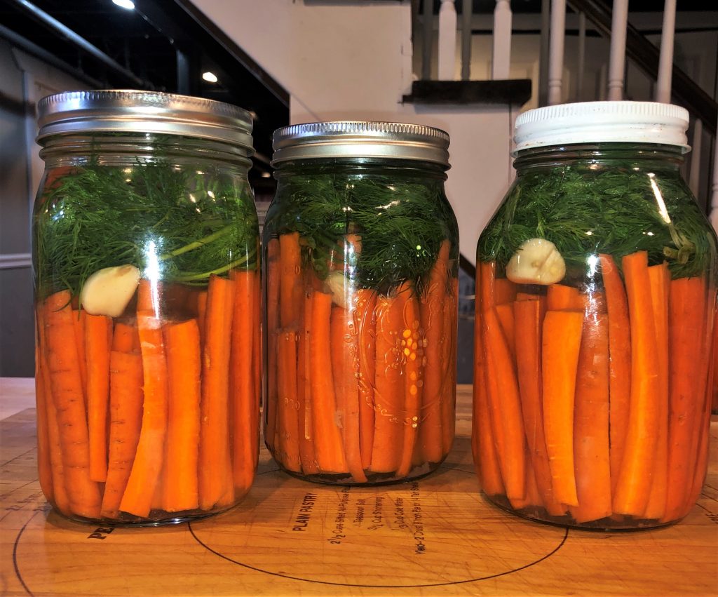 pickled carrots fermenting inside jars